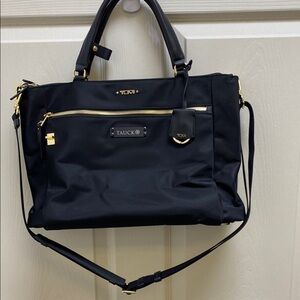 Tumi Black Travel Bag with Adjustable Straps and Minimalist Design